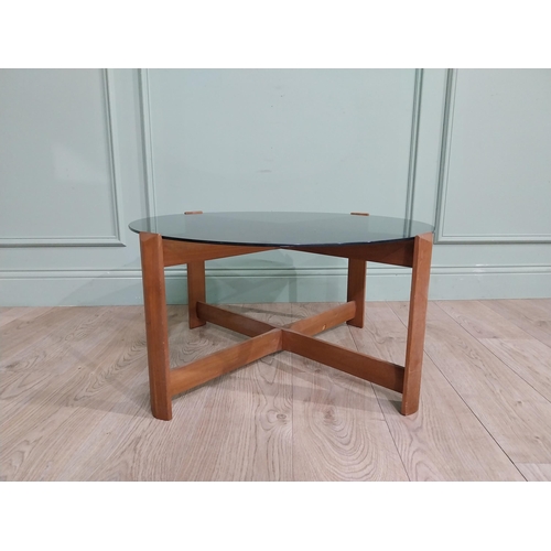 56 - Mid century teak and tinted glass coffee table. {37 cm H x 72 cm Dia.}.