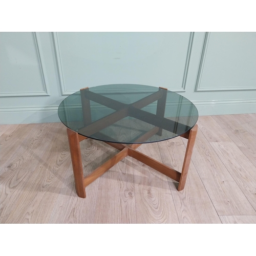 56 - Mid century teak and tinted glass coffee table. {37 cm H x 72 cm Dia.}.