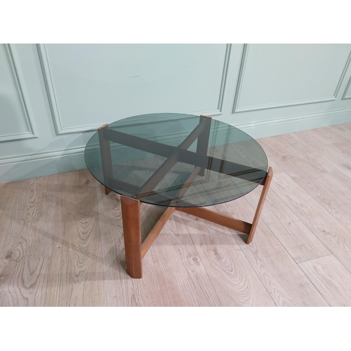 56 - Mid century teak and tinted glass coffee table. {37 cm H x 72 cm Dia.}.