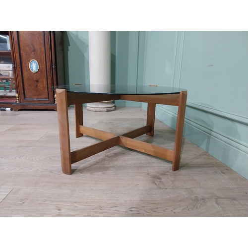 56 - Mid century teak and tinted glass coffee table. {37 cm H x 72 cm Dia.}.