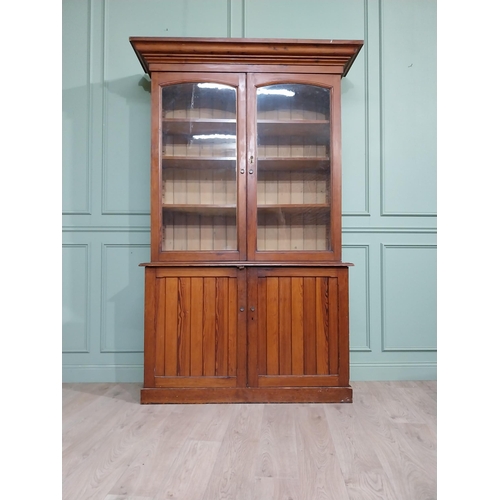 568 - 19th C. Pitch pine bookcase with two glazed doors over two blind doors. {244 cm H x 142 cm W x 48 cm... 