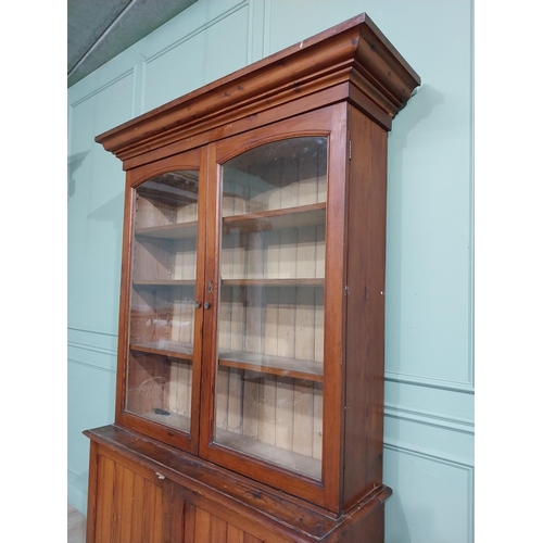 568 - 19th C. Pitch pine bookcase with two glazed doors over two blind doors. {244 cm H x 142 cm W x 48 cm... 