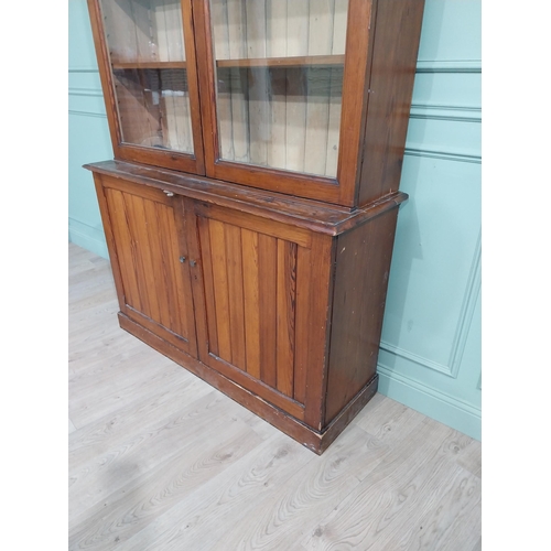 568 - 19th C. Pitch pine bookcase with two glazed doors over two blind doors. {244 cm H x 142 cm W x 48 cm... 