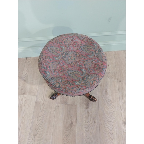 577 - 19th C. Walnut revolving piano stool with upholstered seat on turned column with three outswept feet... 