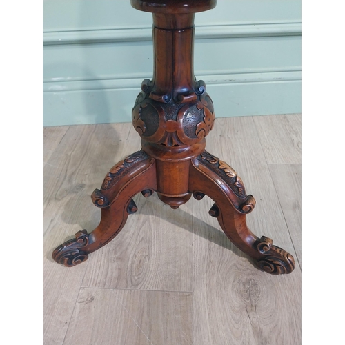 577 - 19th C. Walnut revolving piano stool with upholstered seat on turned column with three outswept feet... 