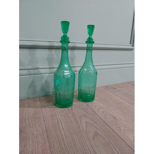 585 - Two green glass decanters. {33 cm H x 7 cm Dia.}.