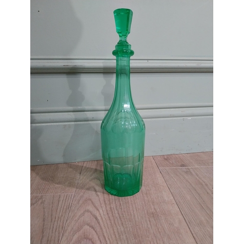 585 - Two green glass decanters. {33 cm H x 7 cm Dia.}.