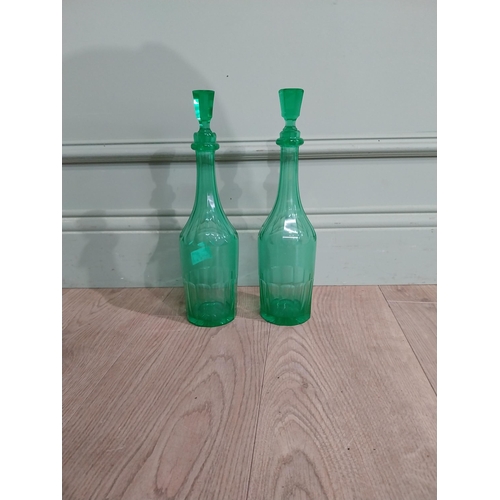 585 - Two green glass decanters. {33 cm H x 7 cm Dia.}.