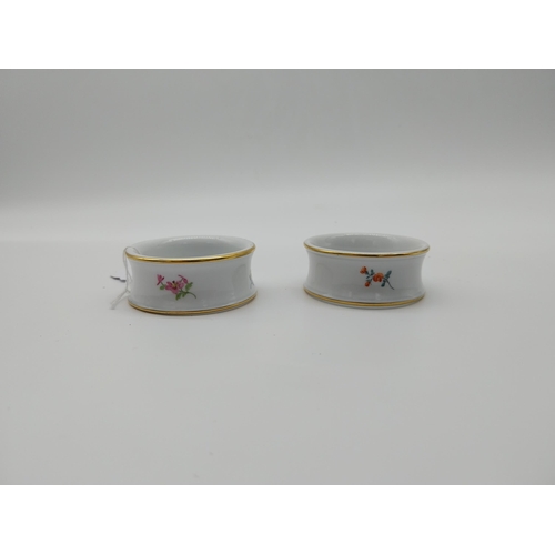 627 - Pair of 20th C. Meissen napkin rings with hand painted floral decoration. Underglazed with blue cros... 