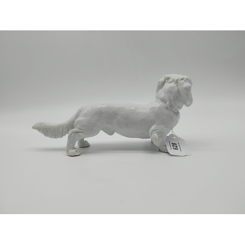 628 - 20th C. Meissen white glazed model of a Long-Haired Dachshund. Underglazed with blue crossed swords.... 