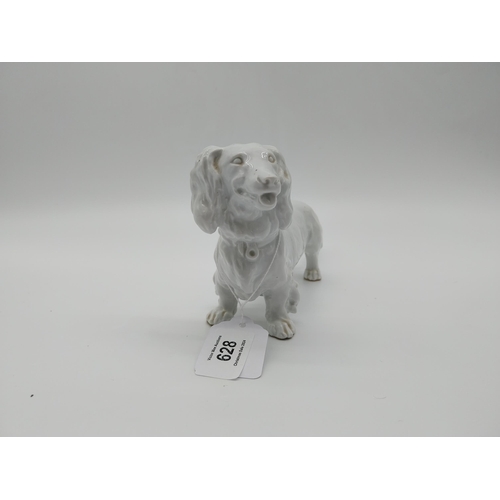 628 - 20th C. Meissen white glazed model of a Long-Haired Dachshund. Underglazed with blue crossed swords.... 