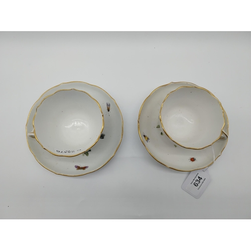 634 - Pair of 19th C. Cups and saucers decorated with Birds and Butterflies. Underglazed with blue crossed... 