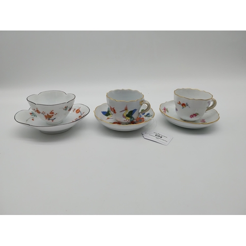 654 - Three 19th C. Meissen demitasse cup and saucer sets decorated with hand painted flowers and one with... 