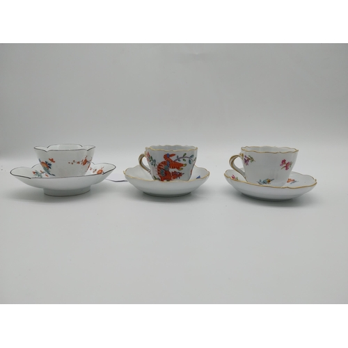 654 - Three 19th C. Meissen demitasse cup and saucer sets decorated with hand painted flowers and one with... 