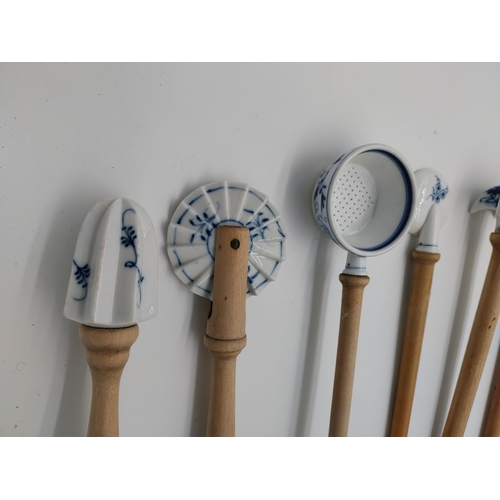 676 - Set of eight wooden handled unmarked Meissen style blue and white Onion patterned ceramic kitchen ut... 