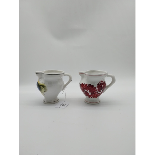 679 - Two Italian ceramic jugs decorated with vines and grapes. {9.5 cm H}.