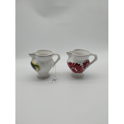 679 - Two Italian ceramic jugs decorated with vines and grapes. {9.5 cm H}.