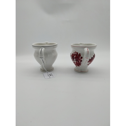 679 - Two Italian ceramic jugs decorated with vines and grapes. {9.5 cm H}.