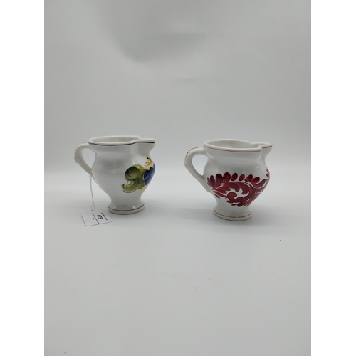 679 - Two Italian ceramic jugs decorated with vines and grapes. {9.5 cm H}.