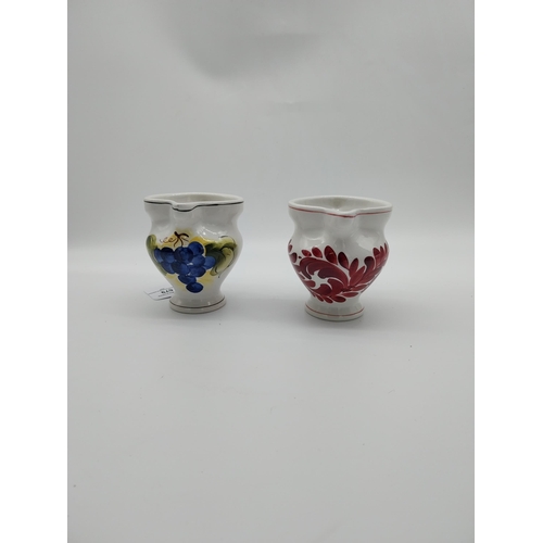 679 - Two Italian ceramic jugs decorated with vines and grapes. {9.5 cm H}.