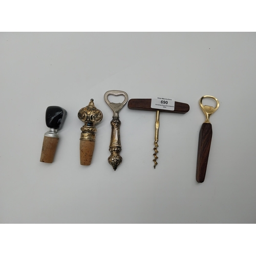 690 - Miscellaneous lot of two corkscrews and one bottle opener and two bottle stoppers.