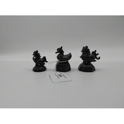 692 - Three 19th C. bronze netsukes � two Dogs of Fu and Duck. {5.5 cm H to 4.5 cm H}.