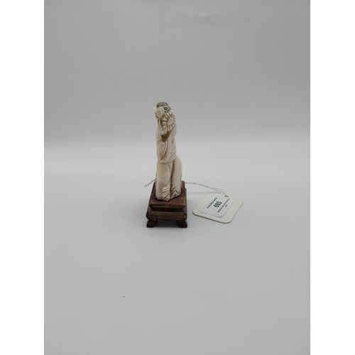 693 - Late 19th C. Chinese carved bone figure on wooden base. {10 cm H}.