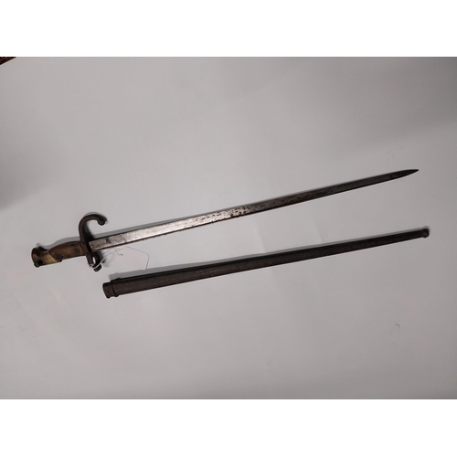 709 - WWI Bayonet with scabbard. {66 cm L}.