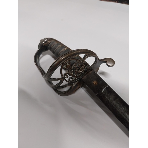 730 - V R Officer�s sword with floral decoration on blade with basket hilt in scabbard.