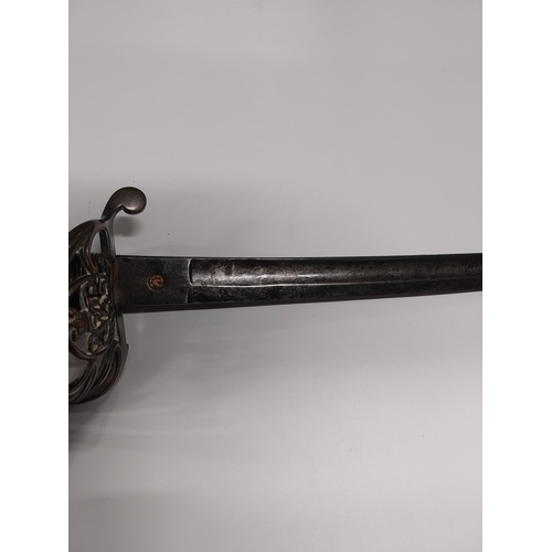 730 - V R Officer�s sword with floral decoration on blade with basket hilt in scabbard.