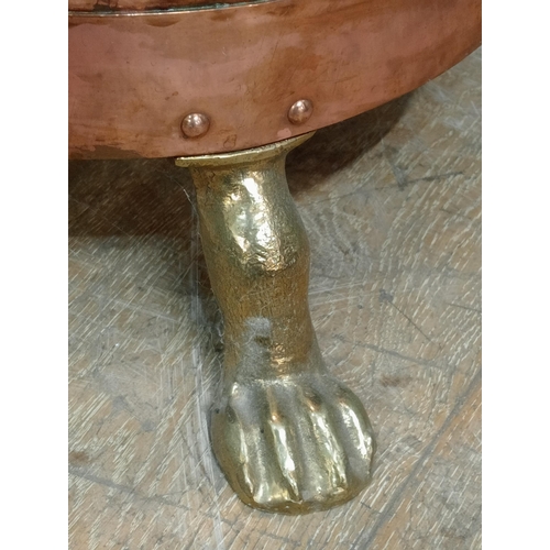 74 - Brass and copper flour bin with copper scoop on three outswept paw feet.  {H 70cm x Dia 50cm}. NOT A... 