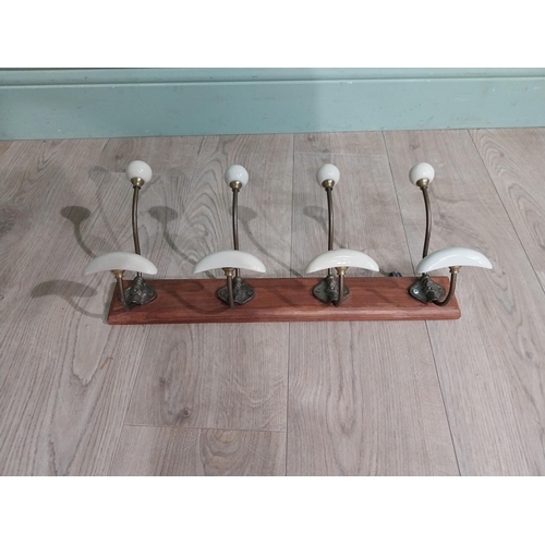 768 - Early 20th C. brass coat hooks mounted on mahogany plaque. [22 cm H x 49 cm W x 14 cm D}.