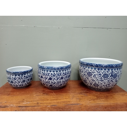 822 - Set of three blue and white oriental flower pots.  {H 21cm x Dia 30cm H, 19cm x Dia 25cm H and 15cm ... 