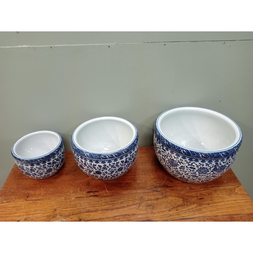 822 - Set of three blue and white oriental flower pots.  {H 21cm x Dia 30cm H, 19cm x Dia 25cm H and 15cm ... 