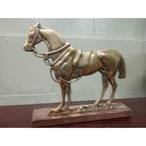 827 - Brass doorstop in the form of a horse. {H 20cm x W 23cm x D 4cm}.  NOT AVAILABLE TO VIEW IN PERSON