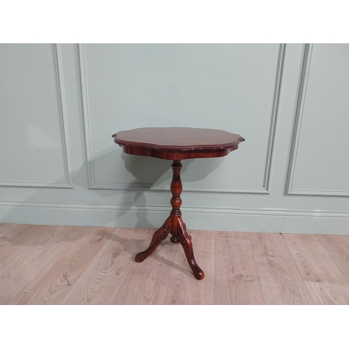 84 - Mahogany and satinwood wine table on turned column on tripod base. {60 cm H x 55 cm Dia.}.