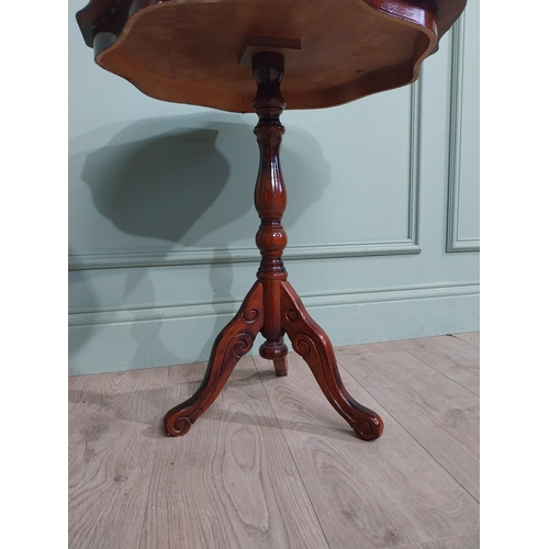 84 - Mahogany and satinwood wine table on turned column on tripod base. {60 cm H x 55 cm Dia.}.