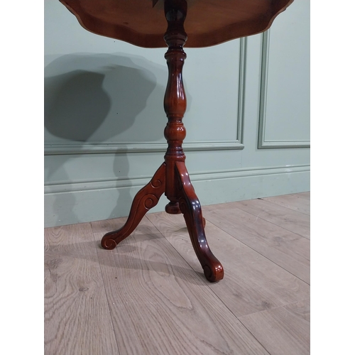 84 - Mahogany and satinwood wine table on turned column on tripod base. {60 cm H x 55 cm Dia.}.