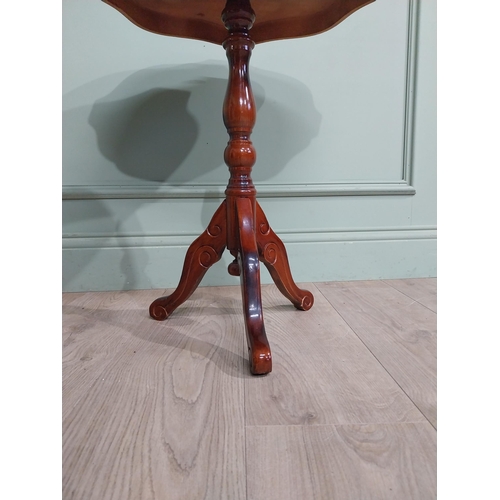 84 - Mahogany and satinwood wine table on turned column on tripod base. {60 cm H x 55 cm Dia.}.