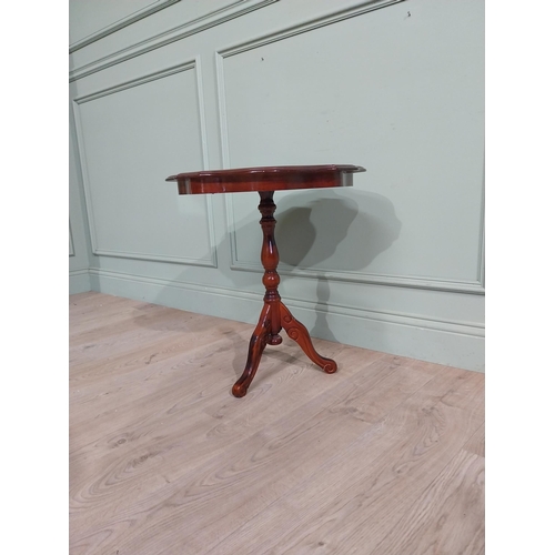 84 - Mahogany and satinwood wine table on turned column on tripod base. {60 cm H x 55 cm Dia.}.