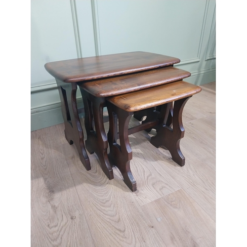 86 - Oak Ercol nest of three tables on shaped supports single stretcher and shaped feet. {42 m H x 57 cm ... 