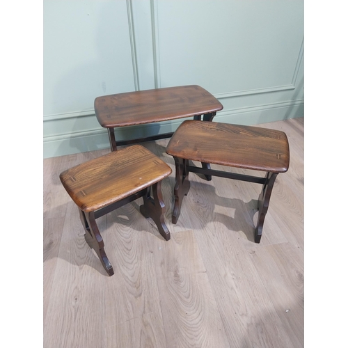 86 - Oak Ercol nest of three tables on shaped supports single stretcher and shaped feet. {42 m H x 57 cm ... 