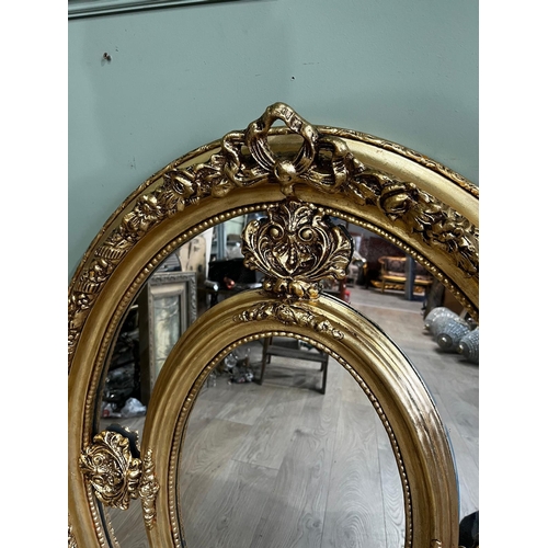 60a - French giltwood wall mirror of oval form surmounted with a bow, in the Victorian style . { 97cm H X ... 