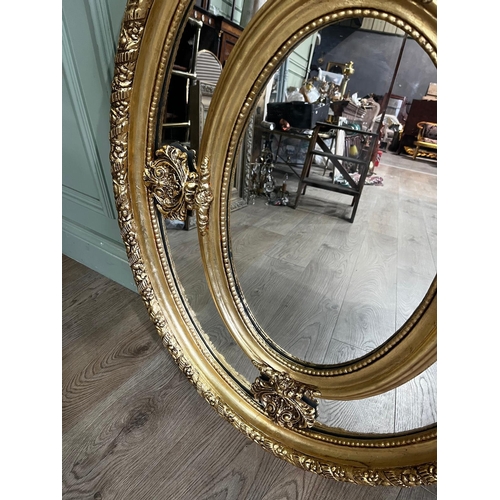 60a - French giltwood wall mirror of oval form surmounted with a bow, in the Victorian style . { 97cm H X ... 