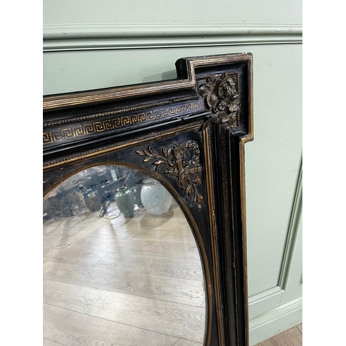 80a - Gilded ebonised wall mirror with oval plate, in the Victorian style. { 105cm H X 71cm W }.