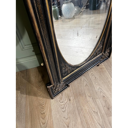 80a - Gilded ebonised wall mirror with oval plate, in the Victorian style. { 105cm H X 71cm W }.