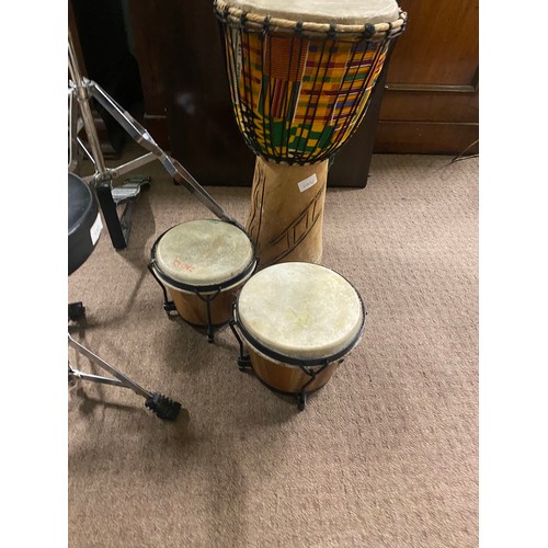 214 - Cymbal on stand with stool and set of Bongo drums .