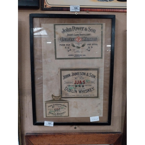 107 - Framed collection of three John Jameson and John Powers Whiskey labels. {44 cm H x 35 cm W}.