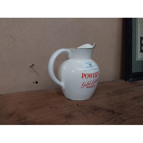 11 - Powers Gold Label Whiskey water jug by Wade. {14 cm H x 14 cm W x 10 cm D}.