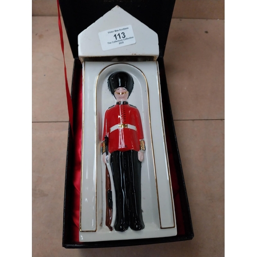 113 - Ceramic bottle in the form of Coldstream Guard. {25 cm H x 9 cm W x 9 cm D}.